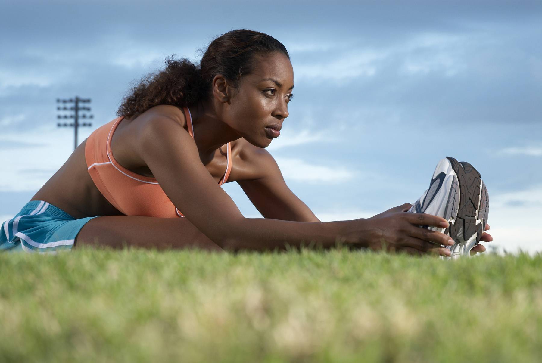 Young woman performing warming up exercises