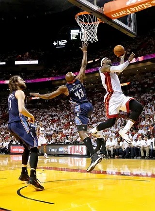 King James Lifts Miami to Victory - The Charlotte Bobcats managed to hang around the defending champion Miami Heat until LeBron James powered a decisive 18-4 run to lead the Heat to a 99-88 victory in game one of their first-round series Sunday. James finished with 27 points and nine rebounds. Bobcats star Al Jefferson left the arena wearing a walking boot after being diagnosed with a strained left foot.(Photo: Mike Ehrmann/Getty Images)