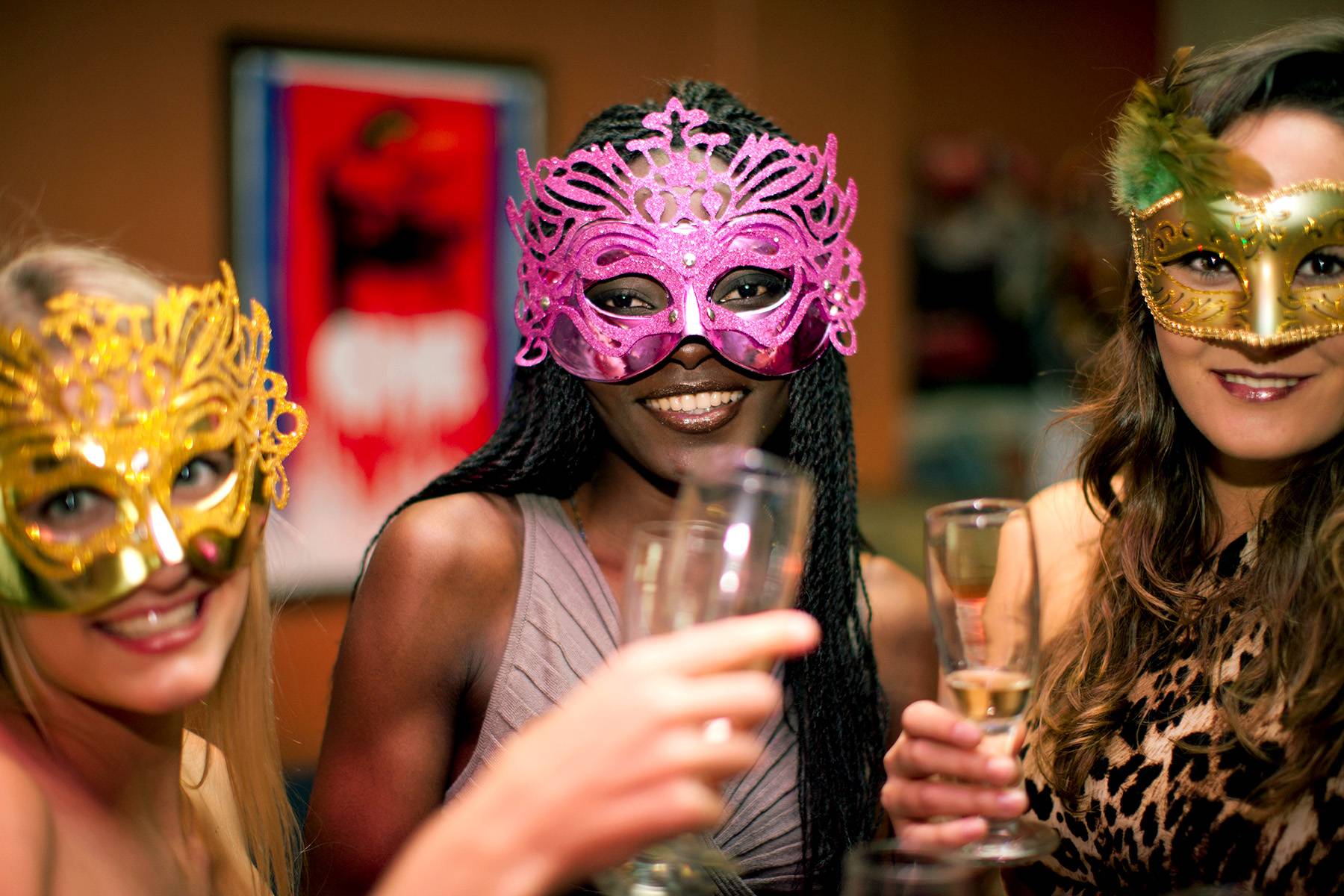 happy women wearing masquerade masks