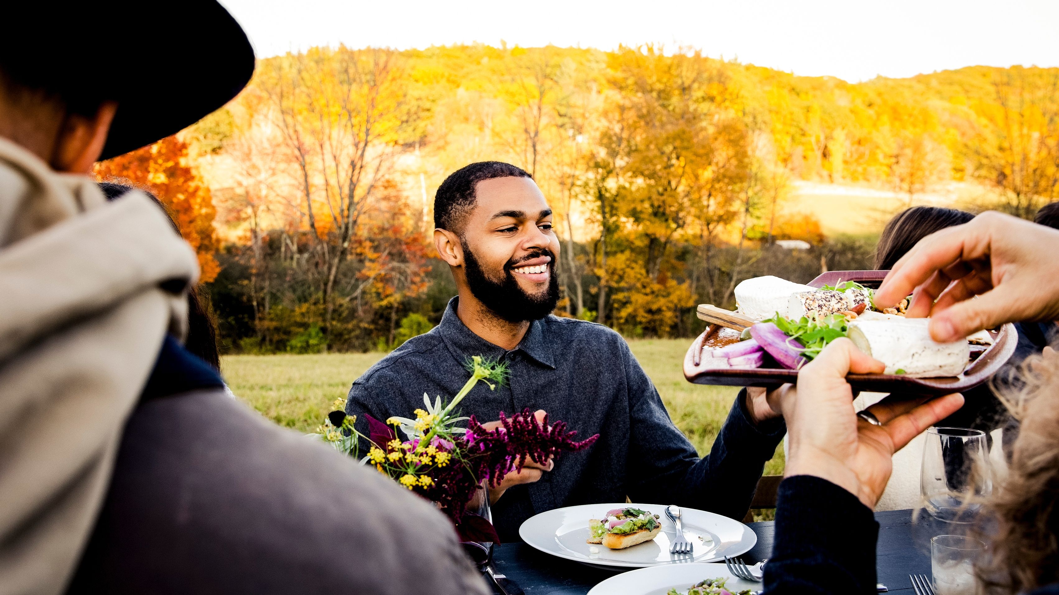Mind Your Money: Friends sharing plates of food.
