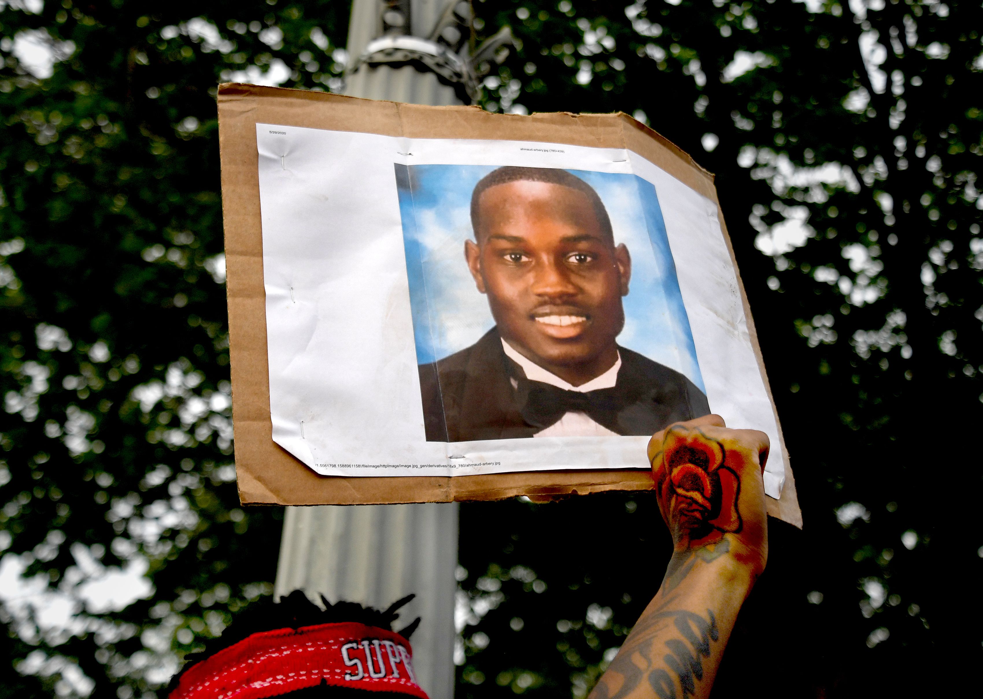 WASHINGTON, DC- MAY 29: Hundreds of activists  protesting the death of George Floyd marched to the White House from 14th and U streets in Washington, D.C on May 29, 2020. One protestor, Michael Robinson, held up a photo of Ahmaud Arbery who was recently killed in Georgia. (not by police officers) The generally peaceful event was marred when one man briefly clashed with uniformed officers of the Secret Service in Lafayette Square park. There were a few other minor scuffles with law enforcement officers but nothing serious. (Photo by Michael S. Williamson/The Washington Post via Getty Images)