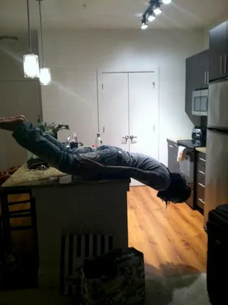 Pill - Atlanta rapper Pill truly performed a balancing act by dangling face first off the edge of a kitchen counter. The young rapper gets major points for this one.&nbsp;(Photo: TwitPic.com)