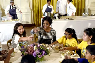 Cheers! - The first lady offers a toast before she and her little gardeners tuck into pumpkin-sweet potato soup and chicken with ratatouille made with produce from the garden.  (Photo: Susan Walsh/AP Photo)