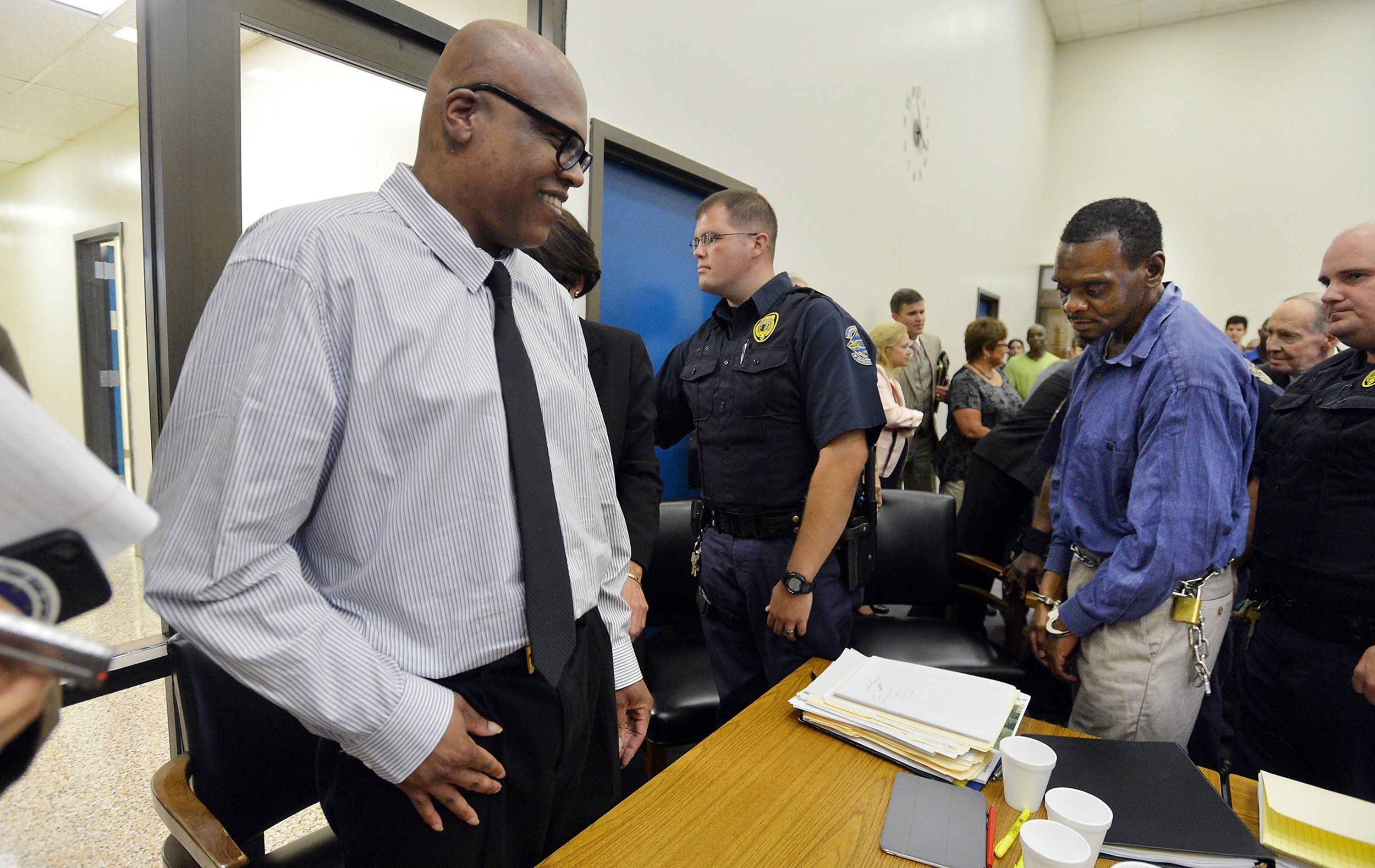 Leon Brown is all smiles as his brother Henry McCollum is led away by guards at the Robeson County Courthouse in Lumberton, N.C. Tuesday, September 2, 2014 after judge has declared McCollum and  Brown innocent of a brutal rape murder for which they have spent 30 years in prison. The brothers were convicted of the 1983 rape and murder of an 11-year-old girl whose body was found in a soybean field near the tiny town of Red Springs. Both were being taken back to their respective facilities to be processed and released. (Chuck Liddy/Raleigh News & Observer/MCT)
