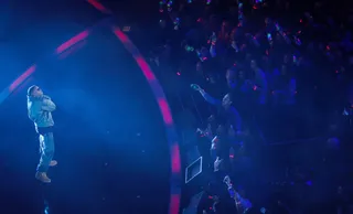 Illmatic - Nas&nbsp;hit the stage to perform his classic "New York State of Mind" at the basketball match between the Western and Eastern Conference All-Star Teams during 2015 NBA All-Star Weekend.&nbsp;(Photo: Cem Ozdel/Anadolu Agency/Getty Images)