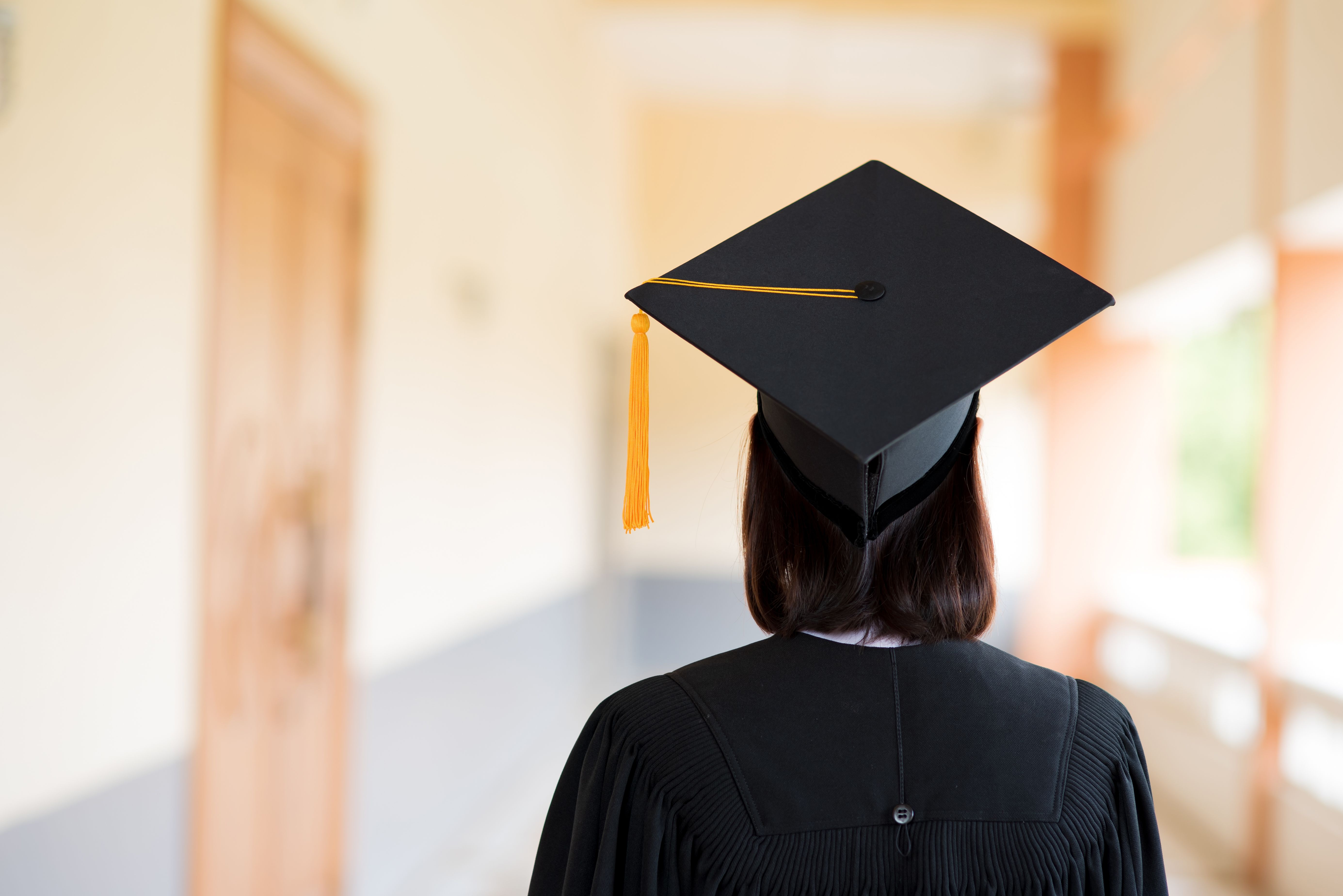 Black graduates wear black suits on graduation day at university.