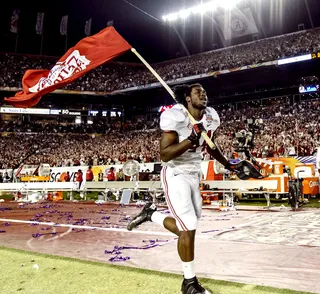 They Are the Champions - Alabama defensive lineman LaMichael Fanning raises the school's flag high. (Photo: Vasha Hunt/AL.COM /Landov)