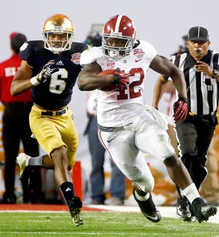 Sayonara! - Alabama's Eddie Lacy blows past Notre Dame cornerback KeiVarae Russell during the second half.&nbsp; (Photo: John Bazemore/AP Photo)