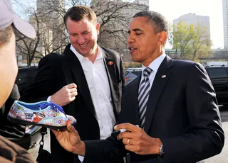 A Shoe-In - An Obama supporter waiting in line to vote has his patience rewarded with a presidential autograph on his shoe.&nbsp;(Photo: JEWEL SAMAD/AFP/Getty Images)