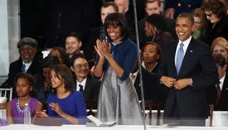 What a View - Mr. and Mrs. Obama take in the parade from the presidential viewing area with daughters Sasha and Malia. (Photo: Mark Wilson/Getty Images)