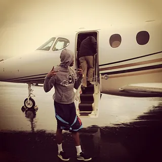 Meek Mill @meekmill - Meek Mill doesn't even have time to look at the camera as he chucks up his dueces while boarding a private jet.(Photo: Instagram via Meek Mill)