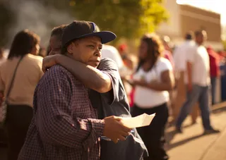 A Reassuring Hug - Dianne Peaches hugs Beatrice Montgomery at a community barbecue in north Minneapolis on Monday. (Photo: AP Photo/Star Tribune, Jeff Wheeler)