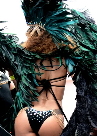 Back Side - Rihanna shows off the rear view of her costume while jumping at the Kadooment Day Parade.&nbsp;  (Photo: Charlie Pitt/246paps/Splash News)