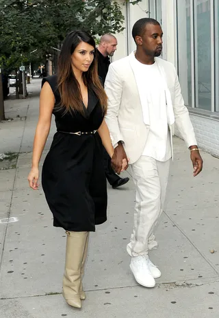 The Finer Things - The doting duo shopped around SoHo (September 2) in their usual monochromatic fits. Kim wore a belted black dress with her Givenchy boots and Kanye rocked a sharp cream suit.(Photo: TNYF\ WENN.com)