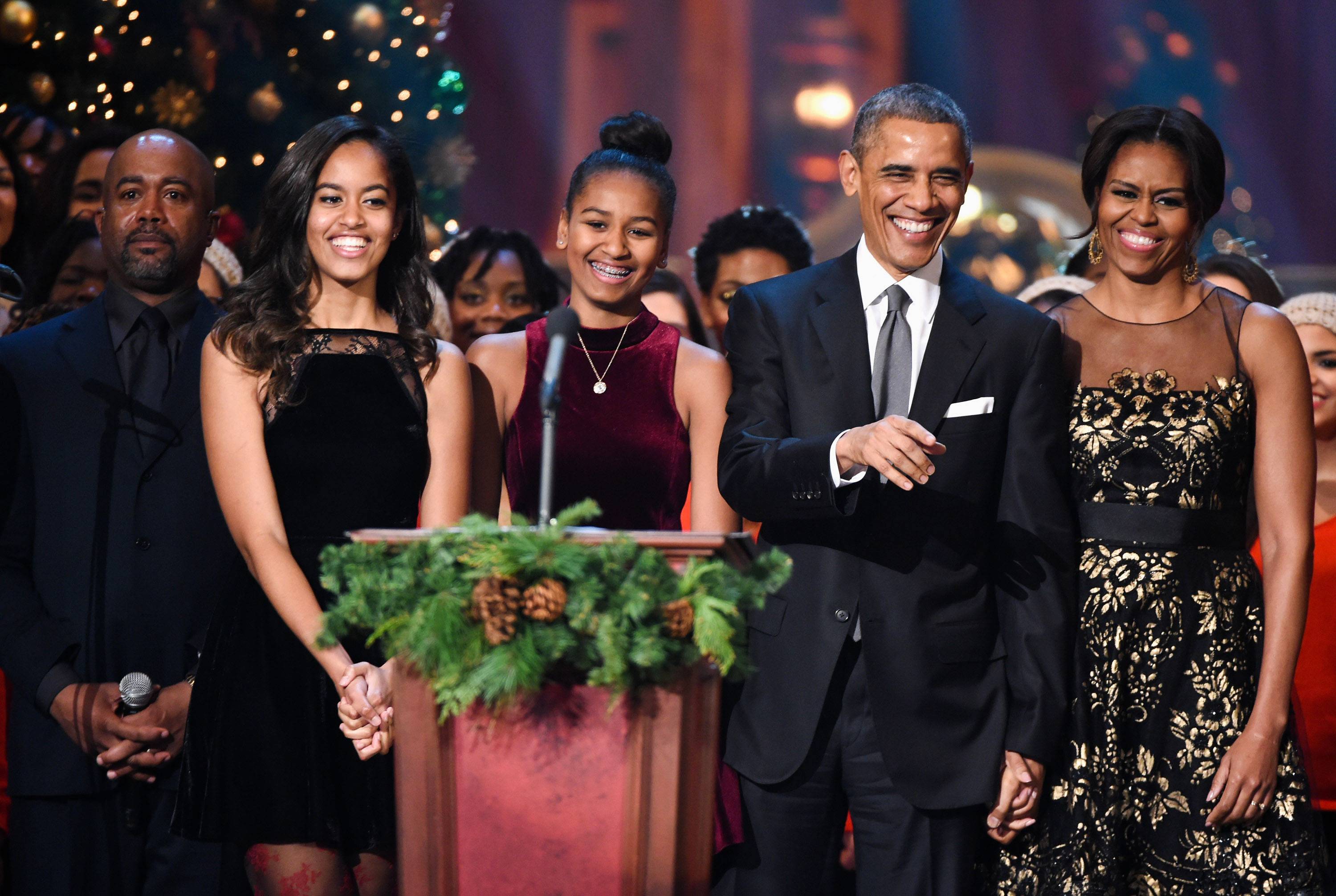 WASHINGTON, DC - DECEMBER 14:  (L-R) Darius Rucker, Malia Obama, Sasha Obama, U.S. President Barack Obama, and First Lady Michelle Obama speak onstage at TNT Christmas in Washington 2014 at the National Building Museum on December 14, 2014 in Washington, DC.  25248_001_0605.JPG  (Photo by Theo Wargo/WireImage)