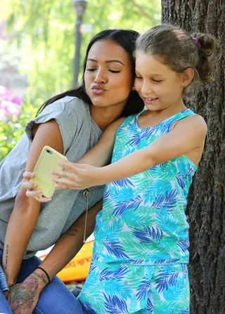 Do Good - Chris Brown's ex-girlfriend Karrueche Tran takes pictures with fans at her Food and Clothing Drive for the homeless in St. James Park in Toronto.  (Photo: S Fernandez / Splash News)