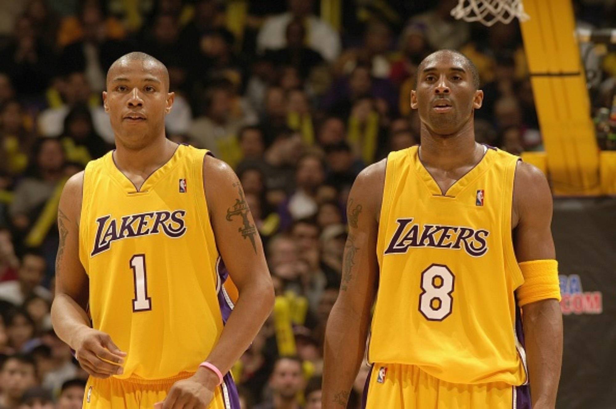 LOS ANGELES - JANUARY 7:   Kobe Bryant #8 and Caron Butler #1 of the Los Angeles Lakers stand during the game with the Houston Rockets on January 7, 2004 at the Staples Center  in Los Angeles, California. The Lakers won 111-104. NOTE TO USER: User expressly acknowledges and agrees that, by downloading and/or using this photograph, User is consenting to the terms and conditions of Getty Images License Agreement. Mandatory Copyright Notice: Copyright 2005 NBAE  (Photo by Noah Graham/NBAE via Getty Images