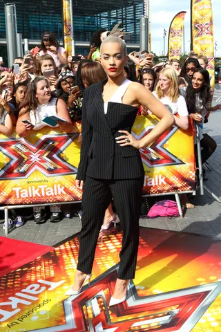 Work and Play - Rita Ora is a little business and a lot of fun in this half suit/half bustier ensemble on the red carpet at the London auditions of The X Factor at SSE Arena.(Photo: Xclusive, PacificCoastNews)