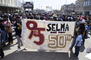 From Near and Far - Travelers from all over joined in the iconic anniversary of the march equipped with handmade banners and flyers.&nbsp;(Photo: Ty Wright/BET)