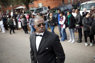 Suited and Booted - A distinguished gentleman looks at the crowd gathering before the service.&nbsp;(Photo: Ty Wright/BET)