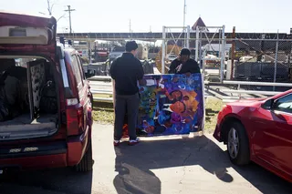 The Art of History - Two artists tote a painted portrait of President Obama surrounded by other Black civil rights leaders to the venue.(Photo: Ty Wright for BET)