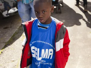 Transcending Age - A young boy joins the crowd gathering to commemorate the 50th anniversary of the march.(Photo: Ty Wright for BET)