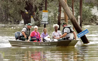 Search and Rescue - People are taken ashore in a boat after being rescued from their homes in high water in the Ninth Ward. The devastation was widespread throughout the city with water reaching 12 feet high in some areas.&nbsp;(Photo: Mario Tama/Getty Images)