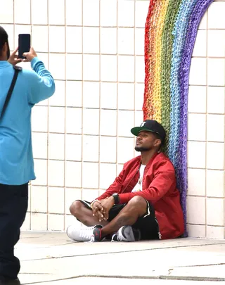 Happy Usher - Usher poses for photos at the base of a rainbow designed mural on Melrose Ave in Los Angeles.(Photo: INSTARimages.com)