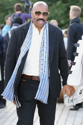 Dress Like a Boss - Steve Harvey leaves the Louis Vuitton S/S 2016 show holding hands with his wife Marjorie during Paris fashion week.(Photo: MCvitanovic / Splash News)