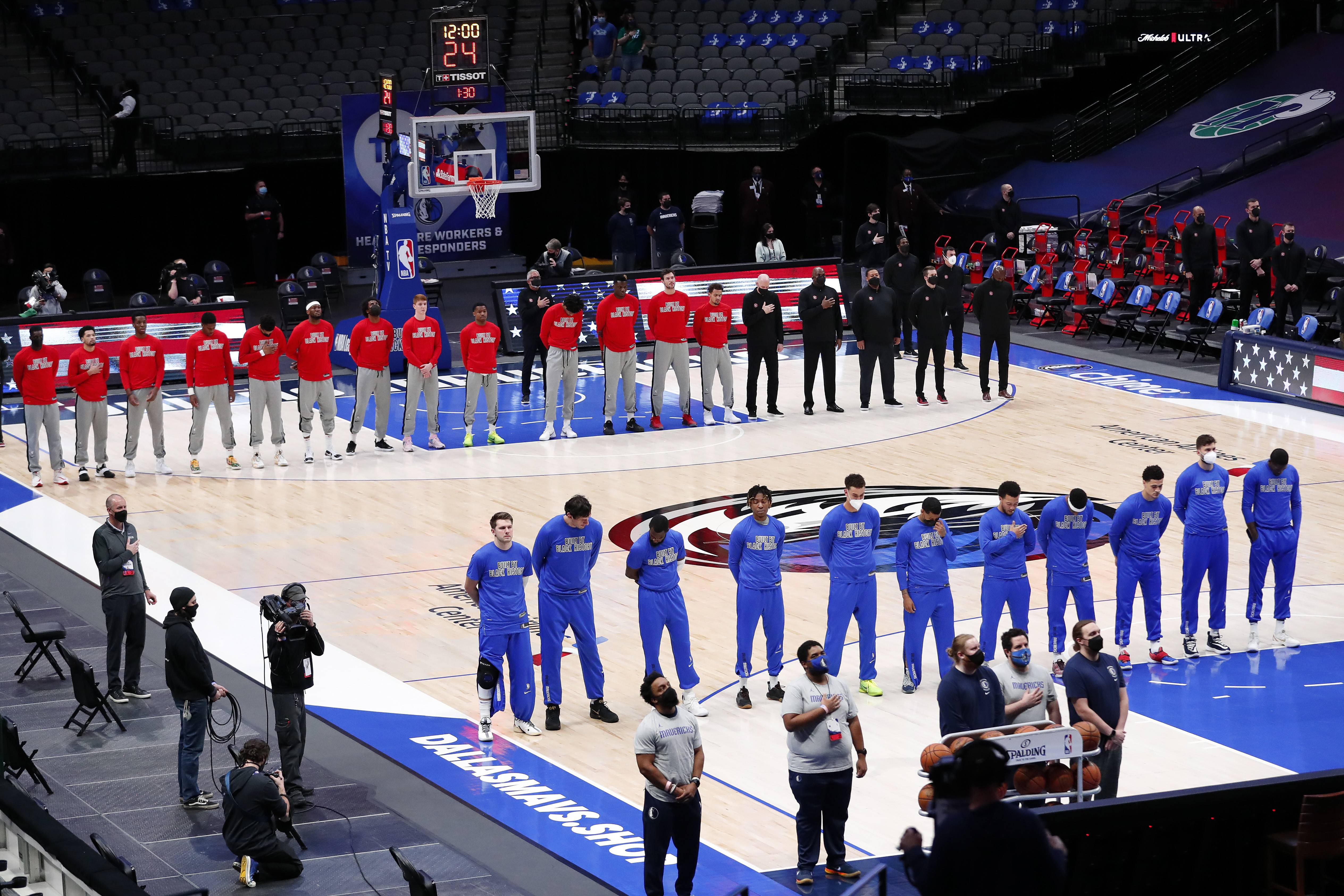 DALLAS, TEXAS - FEBRUARY 10: The Dallas Mavericks and the Atlanta Hawks stand for the National Anthem prior to tipoff of their NBA game at American Airlines Center on February 10, 2021 in Dallas, Texas. NOTE TO USER: User expressly acknowledges and agrees that, by downloading and or using this photograph, User is consenting to the terms and conditions of the Getty Images License Agreement. (Photo by Tom Pennington/Getty Images)