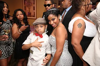 Dapper Baby Guest  - Toya pressed pause on her partying to pose with a dapper young man at her wedding reception.(Photo: Cornell Wheeler)