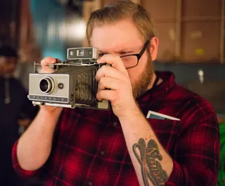 Nice Camera - Apparently RonReaco is not the only photographer on Let's Stay Together. Here is a crew member with an awesome retro camera shooting RonReaco while RonReaco shoots him. (Photo: RonReacos/BET)