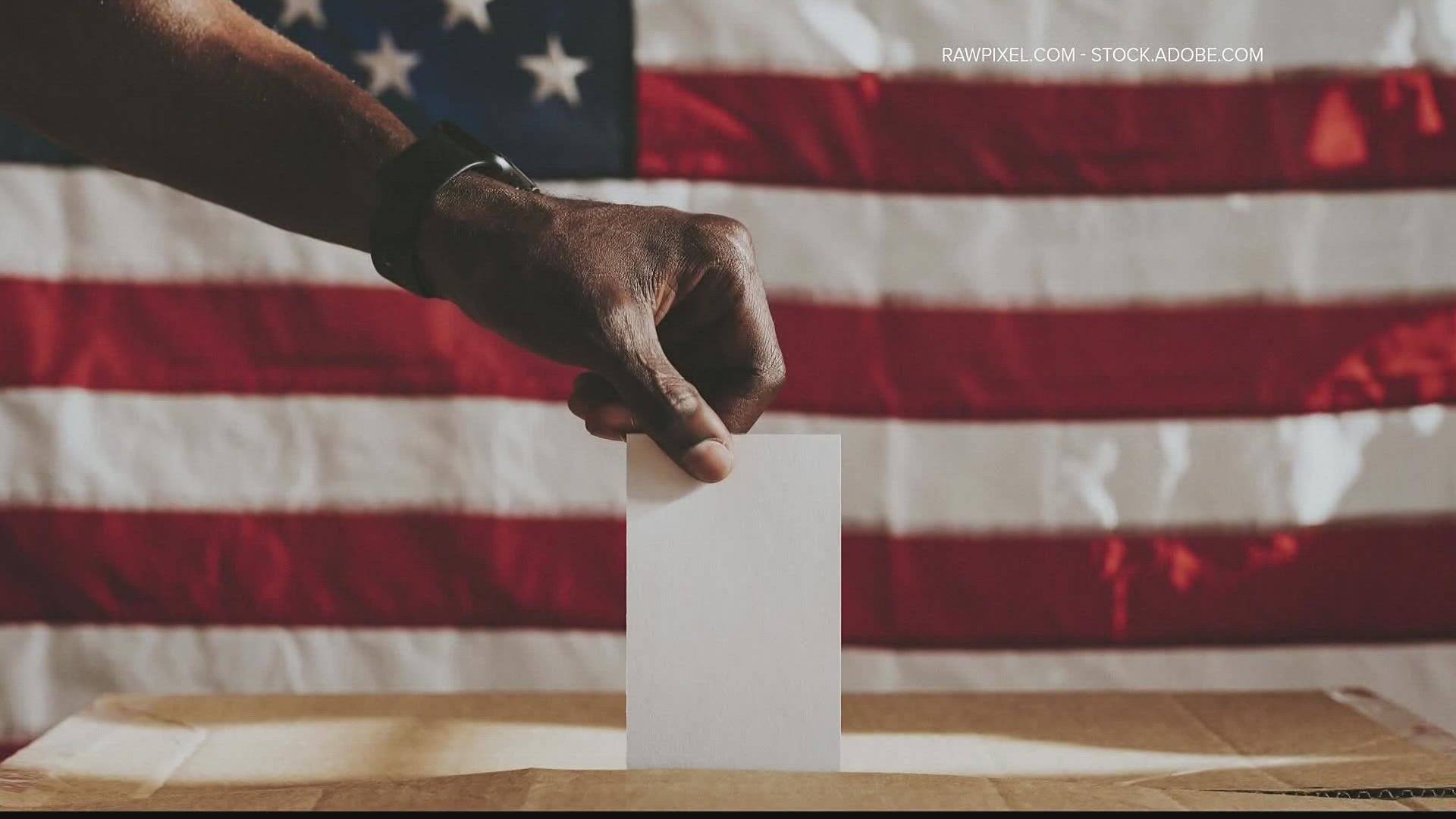 hand putting ballot in box