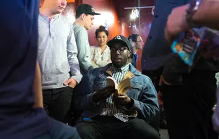 Moment of Zen - Rapper MoRuf gets in some light reading backstage before taking the stage. (Photo: Anna Webber/Getty Images for BET)