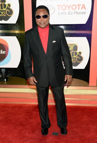 George Benson - The guitar icon added a fiery touch to his satin black suit — a red shirt. It's a look only a true legend would be bold enough to pull off. (Photo: Jason Kempin/Getty Images for BET)