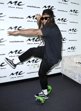 A Leg Up on the Competition - Ty Dollar $ign&nbsp;has a little fun on an e-rover rolling on one leg at the Music Choice studios in NYC.(Photo: Donna Ward/Getty Images)