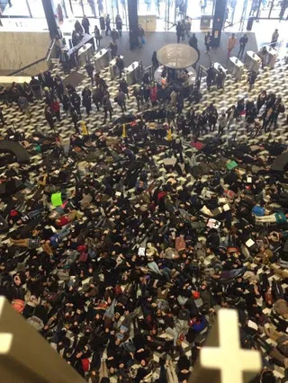 New York University Holds Die-in - New York University's Black Student Union hosted a die-in on the main floor of the school's Bobst Library on Dec. 10. This comes after a demonstration during the school's &quot;Welcome Week&quot; for victims of police brutality and racial profiling. The students lay down along with their peers of all races in solidarity.&nbsp;(Photo: Julie Marinet)