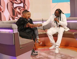 Glance at the Ring - Bow Wow takes a look at 2 Chainz' jewels on 106. (Photo: Bennett Raglin/BET/Getty Images for BET)