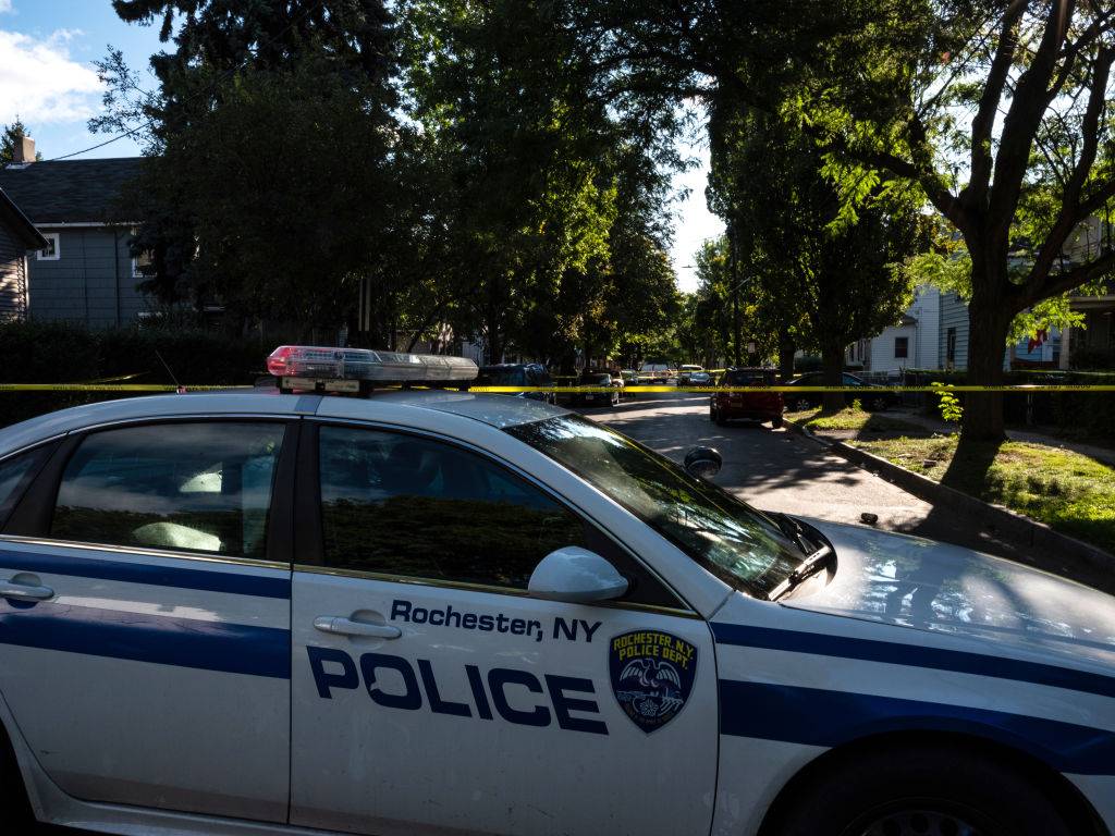 ROCHESTER, NY - SEPTEMBER 19: Police officers investigate a crime scene after a shooting at a backyard party on September 19, 2020, Rochester, New York. Two young adults - a man and a woman - were reportedly killed, and 14 people were injured in the shooting early on Saturday morning on the 200th block of Pennsylvania Avenue, located in the city's Marketview Heights neighborhood. Police say several dozen shots were fired. (Photo by Joshua Rashaad McFadden/Getty Images)