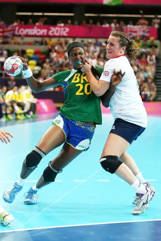 Brazil Is Victorious - Fernanda Silva Rocha of Brazil attempts to throw a goal past Louise Jukes of Great Britain before the team's win in the women's handball preliminaries group A match. (Photo: Jeff Gross/Getty Images)