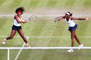 It Takes Two - U.S. tennis star Serena Williams prepares to attack a loose ball while playing in a women's doubles tennis match with sister Venus.&nbsp;(Photo: Clive Brunskill/Getty Images)