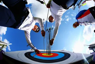 Aiming for Gold - Im Dong-Hyun of Korea retrieves his arrows from the board while practicing for the men's individual archery event.&nbsp;(Photo: Paul Gilham/Getty Images)