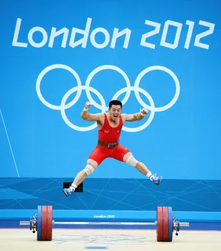 Sweet Success&nbsp; - Un Guk Kim of Korea celebrates making a world record while competing in the men's 62kg weightlifting competition. (Photo: Laurence Griffiths/Getty Images)