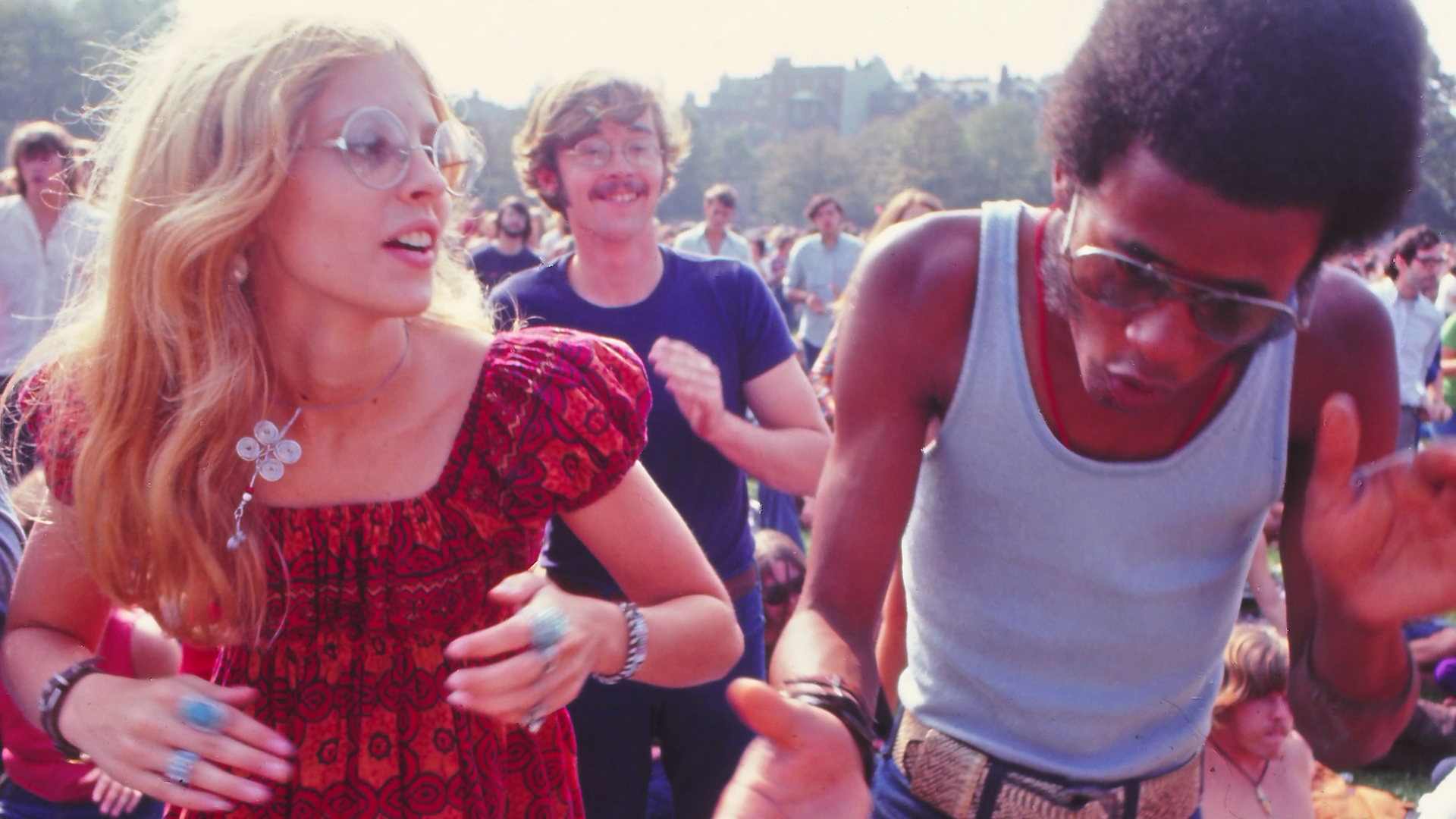 A woman and a man dancing in a festival.