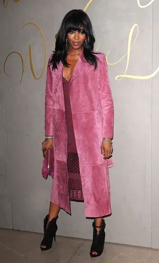 #Flawless - Just call her Naomi the Fashion Slayer! Supermodel Ms. Campbell gives us effortless chic in a suede raspberry trench and matching sheath at the the premiere of the Burberry Festive Film in London.  (Photo: Splash News)