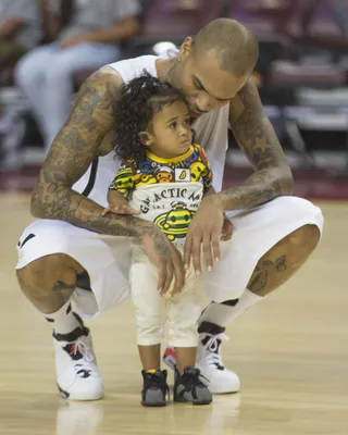 Baby Ballin' - Chris Brown brings Royalty out on the court during halftime at the Power 106 celebrity basketball game in Los Angeles.(Photo: Holly Heads LLC / Splash News)