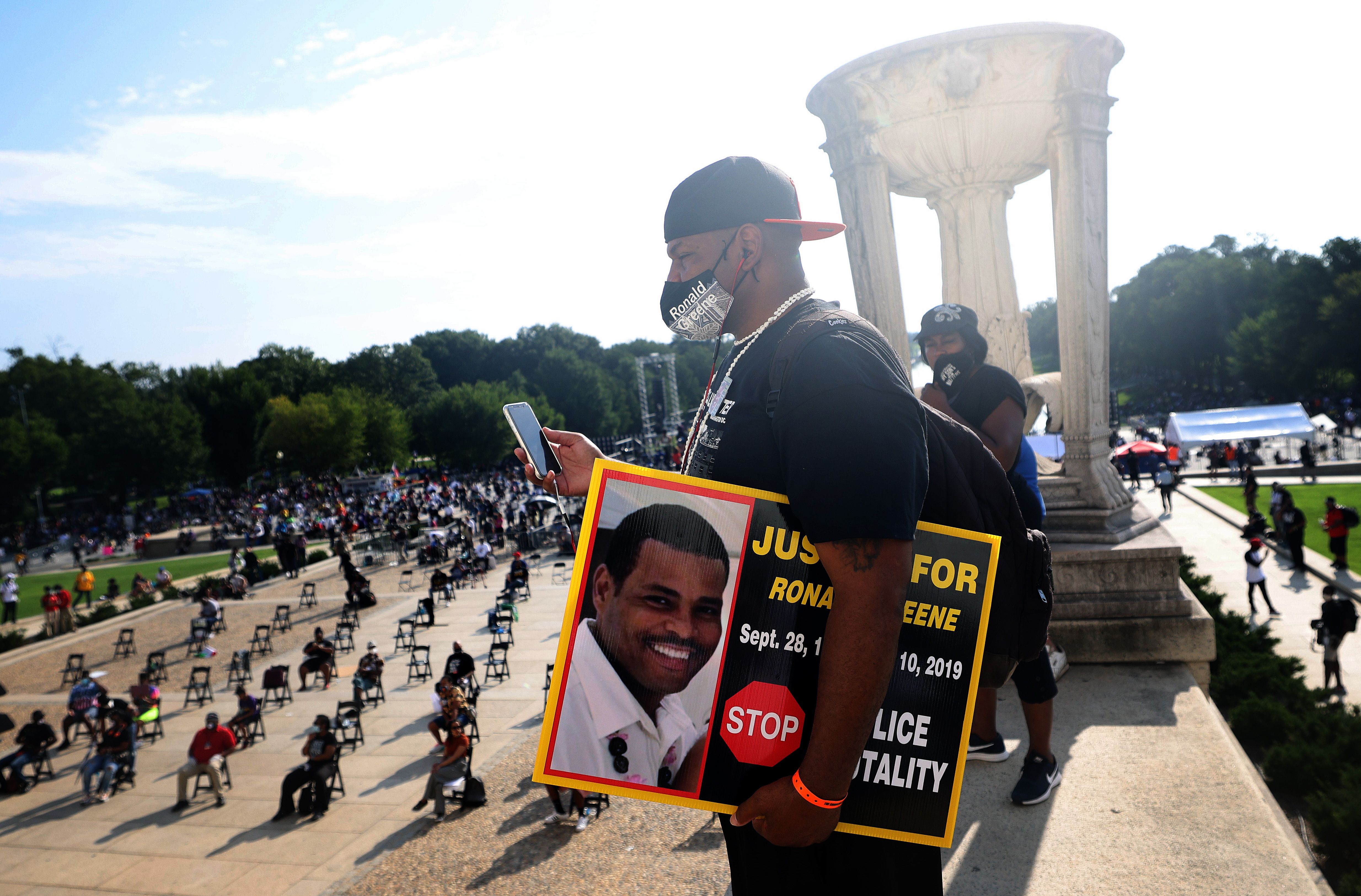 WASHINGTON, DC - AUGUST 28: Sean Green, brother of Ronald Greene, listens to speakers at the Lincoln Memorial during the March on Washington August 28, 2020 in Washington, DC. Ronald Greene died in police custody following a high-speed chase in Louisiana in 2019. Today marks the 57th anniversary of Rev. Martin Luther King Jr.'s "I Have A Dream" speech at the same location. (Photo by Michael M. Santiago/Getty Images)