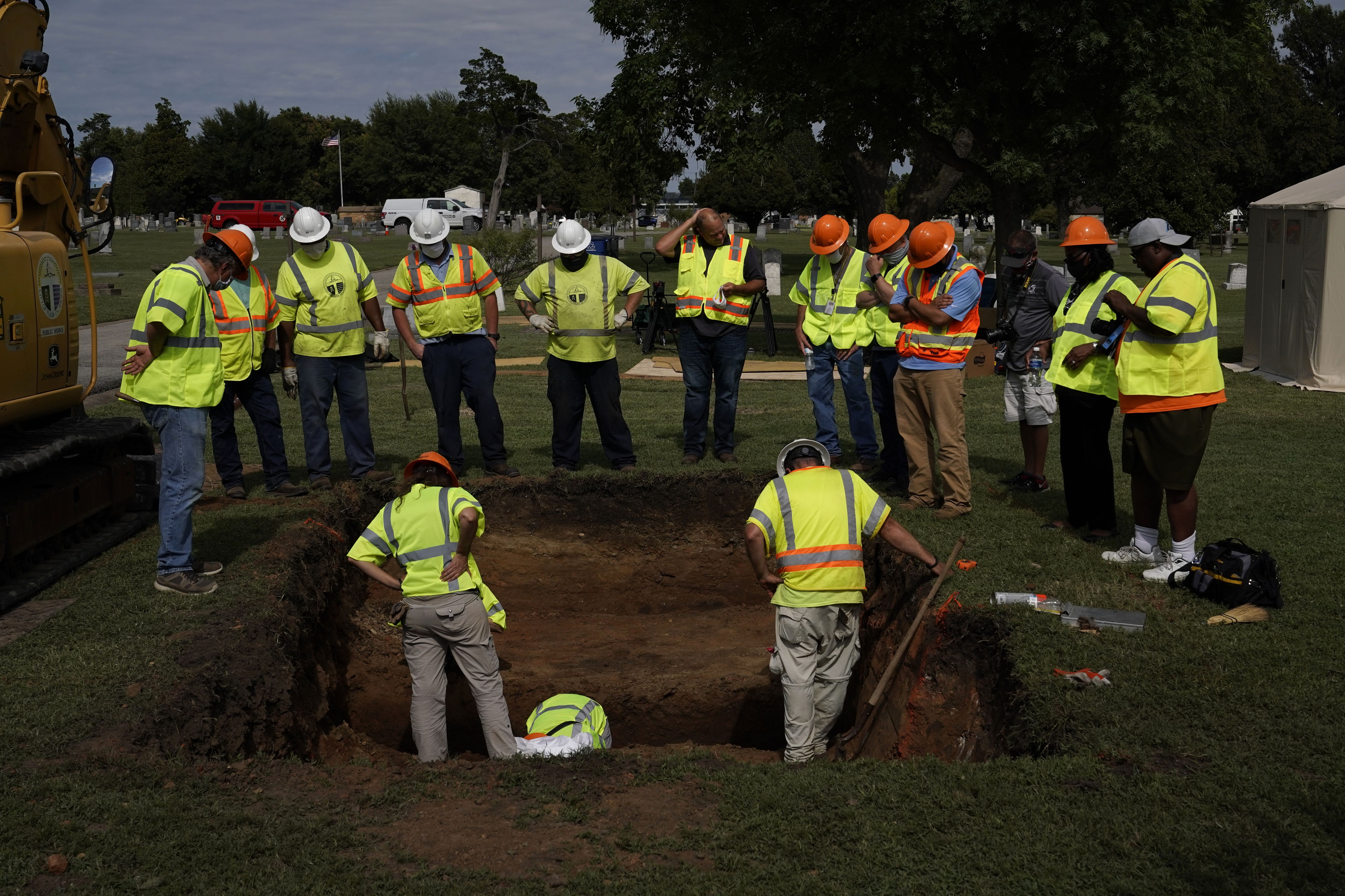 TULSA, OKLAHOMA - July 13:  Archaeologists and researchers examine a hole that was dug during a test excavation of the possible 1921 Tulsa Race Massacre Graves at Oaklawn Cemetery in Tulsa, Oklahoma on July 13, 2020. (Photo by Nick Oxford for The Washington Post)