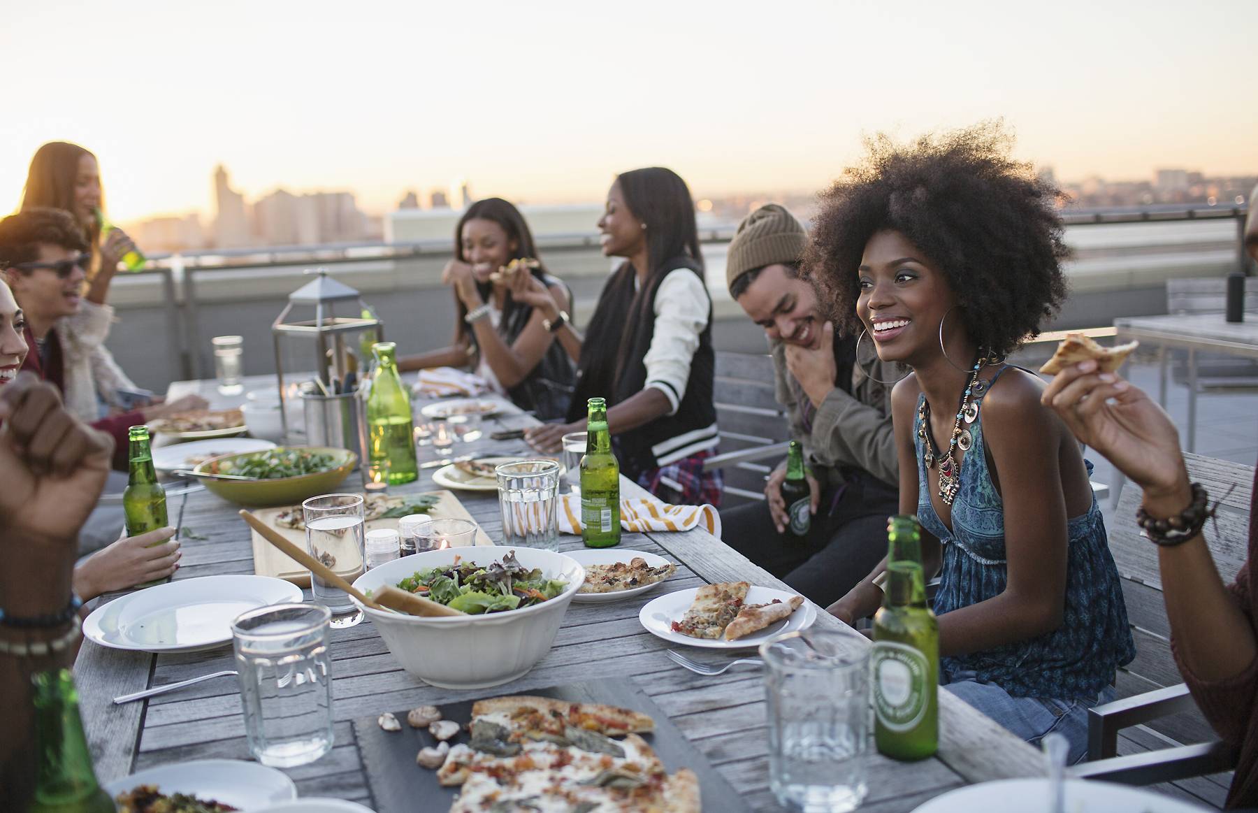 friends enjoying meal on rooftop