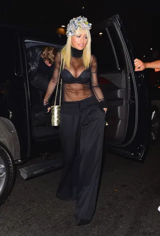 Cuttin' Up - Rita Ora shows off her goodies in a sheer top with wide leg pants and an interesting flower hat as she arrives to 1 OAK nightclub in NYC with her sister and a few friends.&nbsp;(Photo: 247PAPS.TV / Splash News)